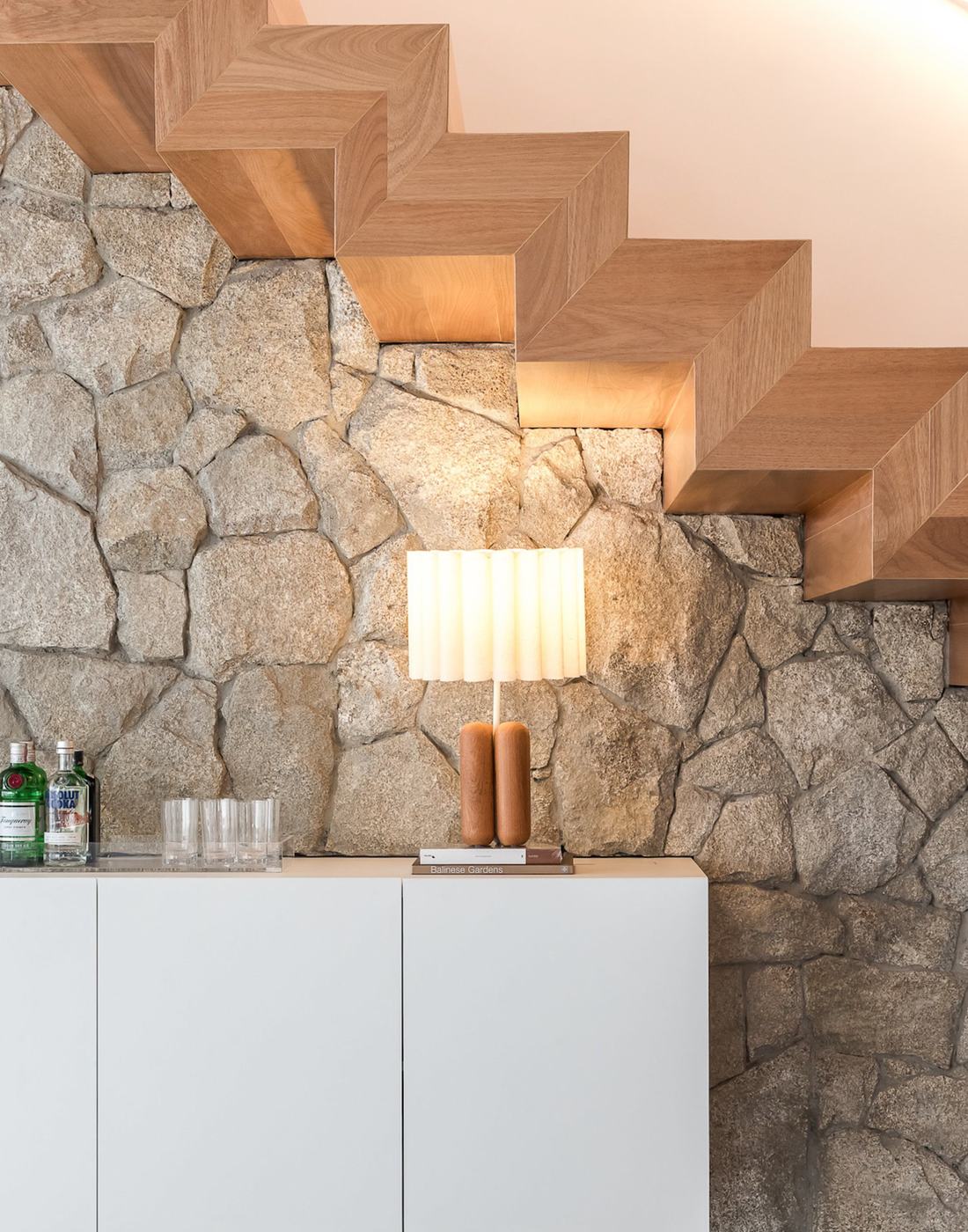 Tauari Champagne timber used on a floating staircase against a stone wall